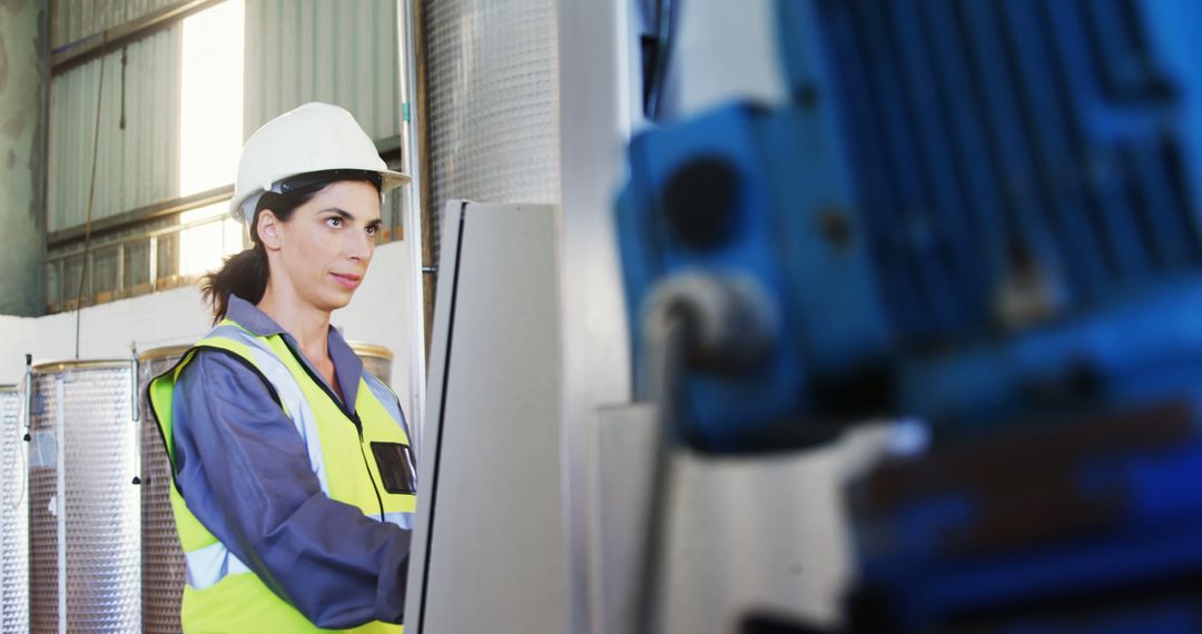 Female Engineer Operating Machinery in Industrial Factory - Free Images, Stock Photos and Pictures on Pikwizard.com