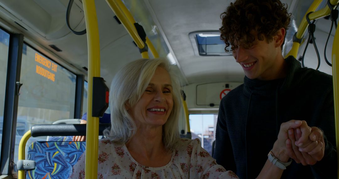 Senior woman and young man smiling while riding bus - Free Images, Stock Photos and Pictures on Pikwizard.com