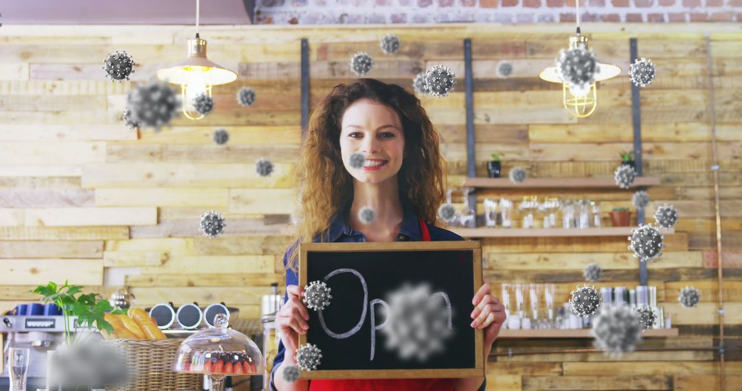Barista Holding Sign Amid Floating Virus Particles in Cozy Cafe