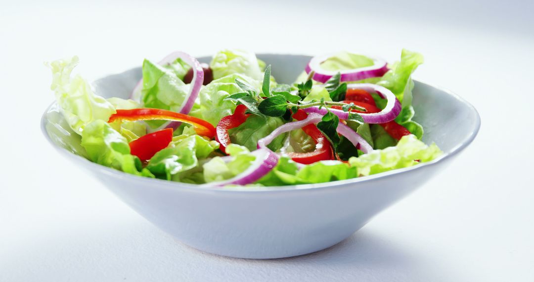 Fresh Vegetable Salad in a White Bowl with Red Onion and Bell Pepper - Free Images, Stock Photos and Pictures on Pikwizard.com