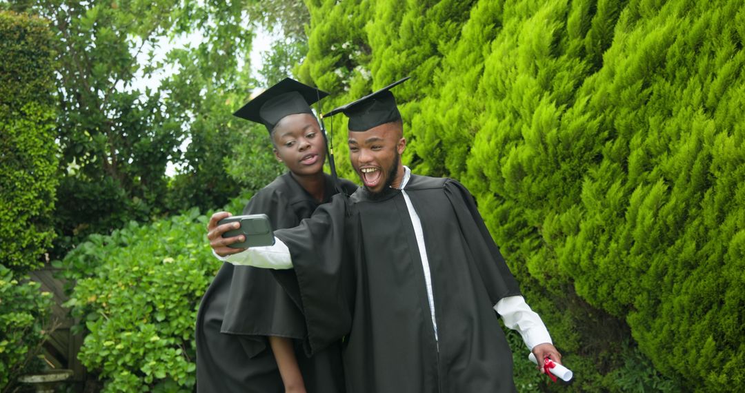 Joyful Graduating Students Taking Selfie with Diploma Outdoors