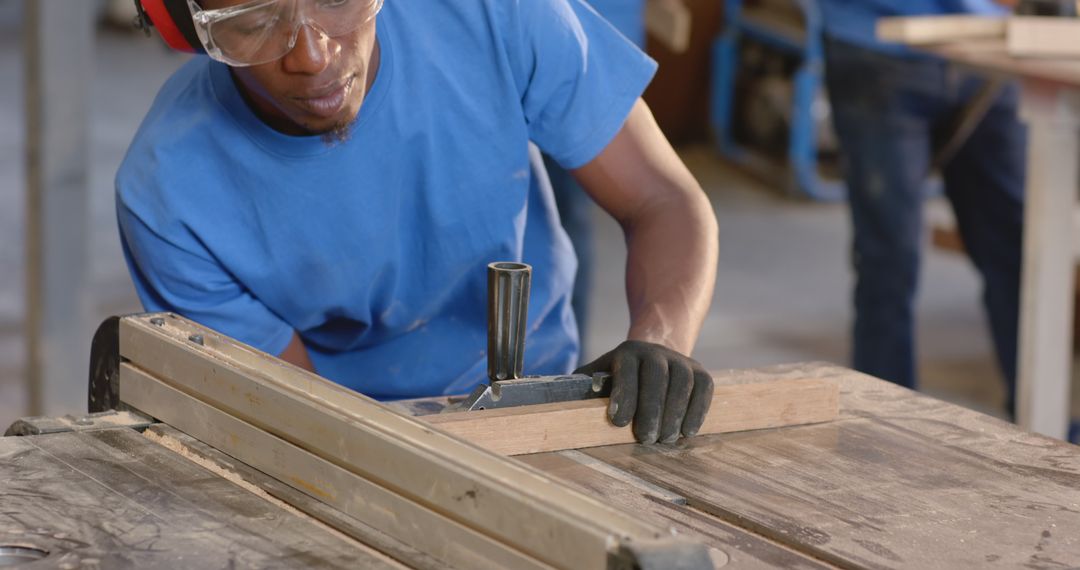 Carpenter Using Table Saw Wearing Safety Gear