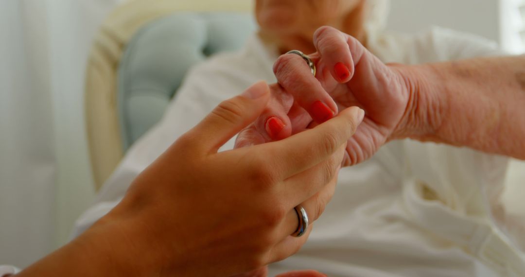 Caregiver Holding Hand of Elderly Woman with Red Nail Polish - Free Images, Stock Photos and Pictures on Pikwizard.com