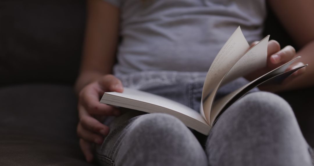 Close-up of Person Reading book on Couch - Free Images, Stock Photos and Pictures on Pikwizard.com