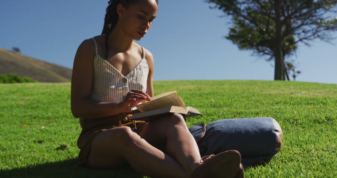 Woman Reading Book Outdoors in Sunny Park - Free Images, Stock Photos and Pictures on Pikwizard.com