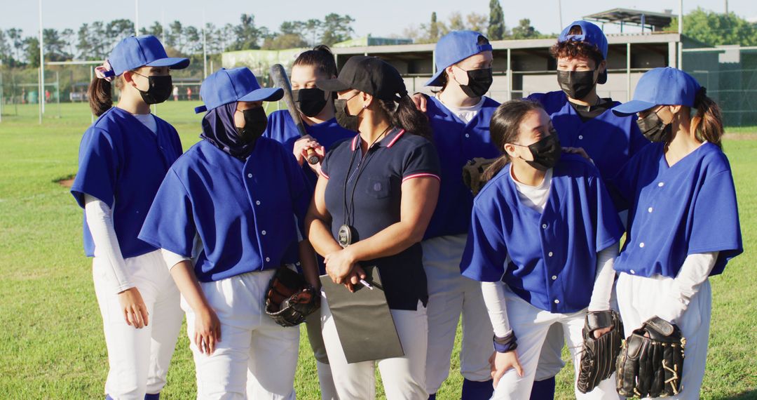 Masked Baseball Team Listening to Coach on Field - Free Images, Stock Photos and Pictures on Pikwizard.com