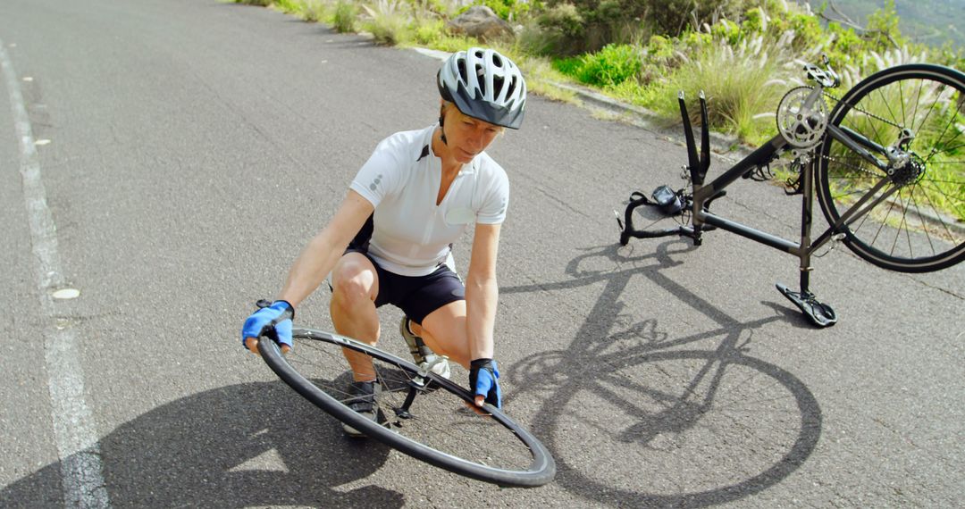 Cyclist Fixing Bicycle Tire on Roadside - Free Images, Stock Photos and Pictures on Pikwizard.com