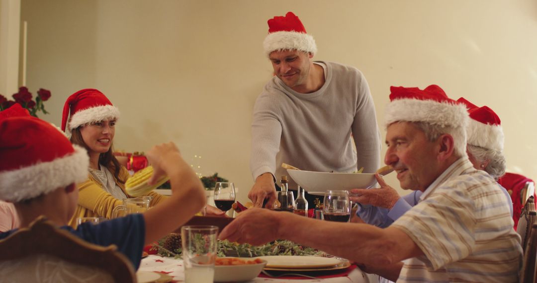 Family Celebrating Christmas Dinner Together Wearing Santa Hats - Free Images, Stock Photos and Pictures on Pikwizard.com