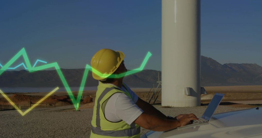 Engineer Working Remotely at Wind Turbine with Data Overlay