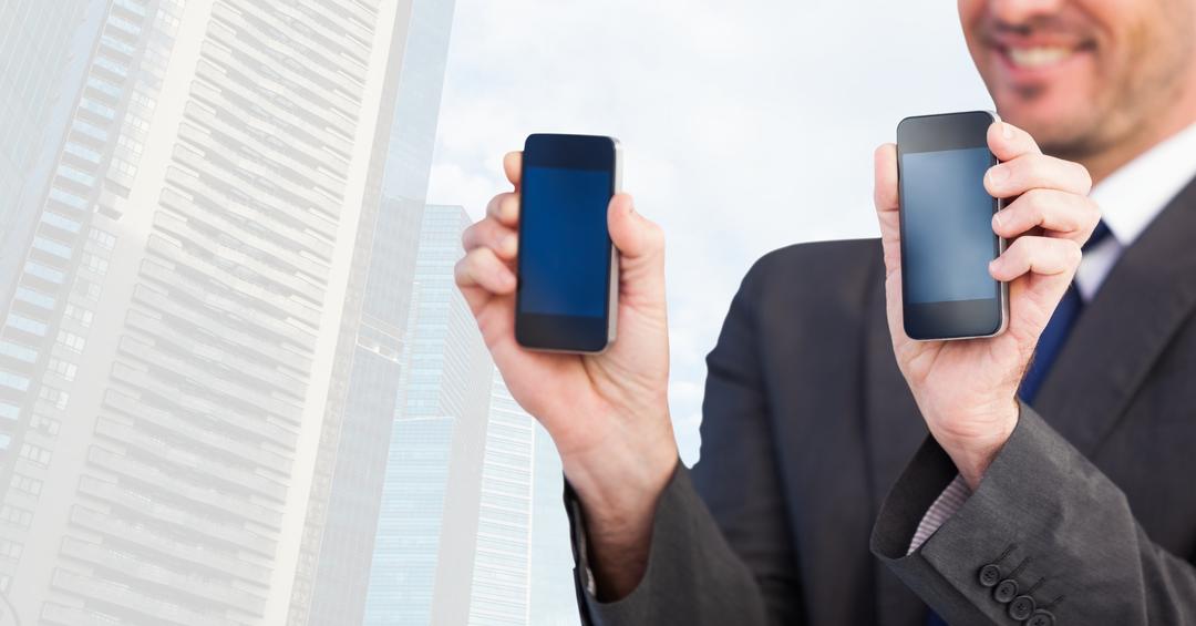 Businessman Displaying Blank Smartphones Against Cityscape Background - Free Images, Stock Photos and Pictures on Pikwizard.com