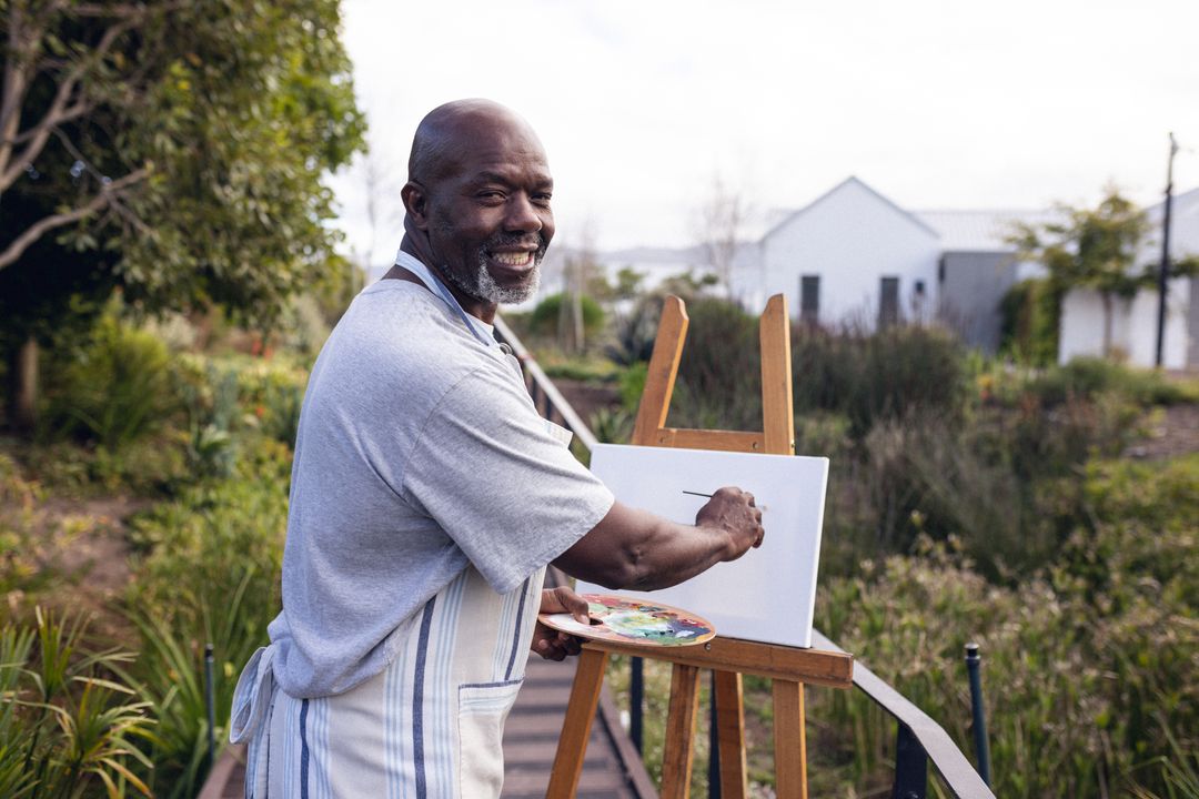Image of happy african american man painting in garden - Free Images, Stock Photos and Pictures on Pikwizard.com