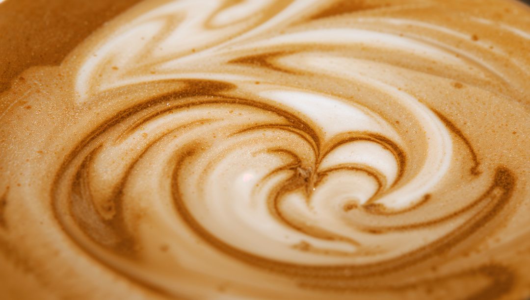 Close-Up of Intricate Swirling Latte Art Design with Warm Tones