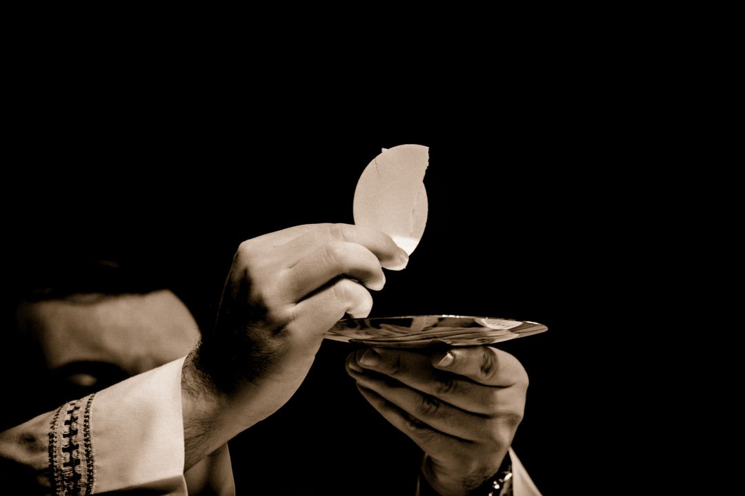 Priest Hands Holding Communion Wafer During Eucharist Ceremony - Free Images, Stock Photos and Pictures on Pikwizard.com