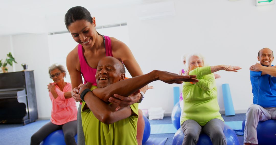 Fitness Instructor Assisting Senior Group in Stretching Class