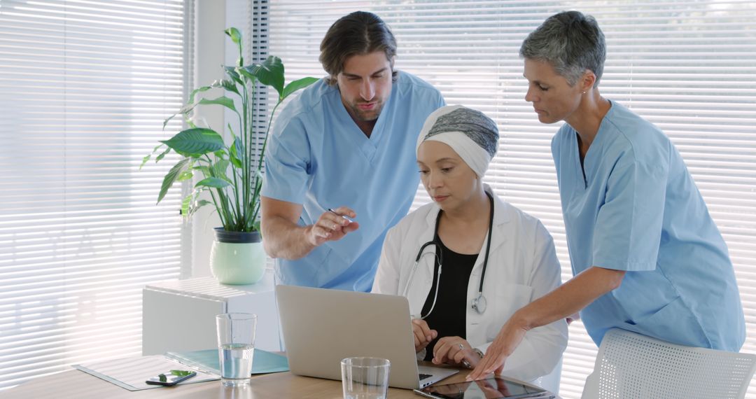 Medical Team Collaborating with Digital Devices in Modern Office - Free Images, Stock Photos and Pictures on Pikwizard.com