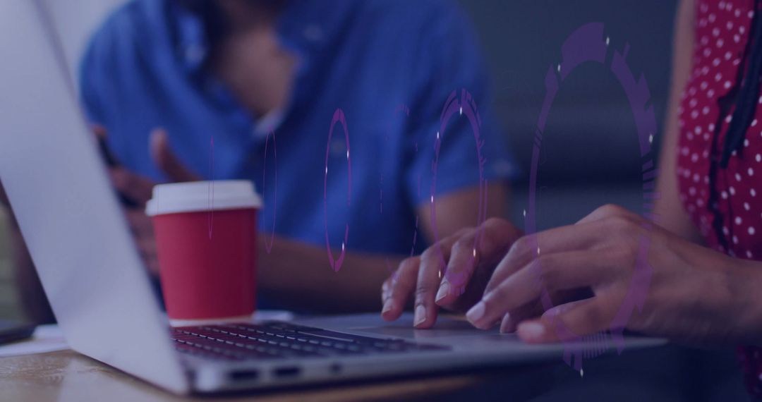 Creative Workspace with Laptop Typing and Coffee Collaboration