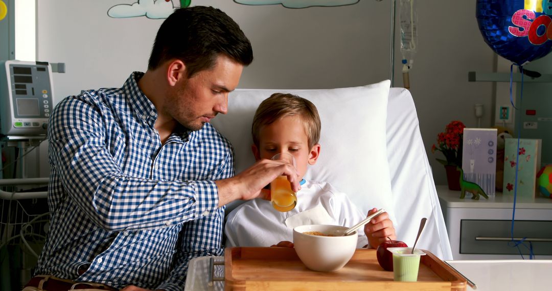 Caring Father Feeding Son in Hospital Room - Free Images, Stock Photos and Pictures on Pikwizard.com