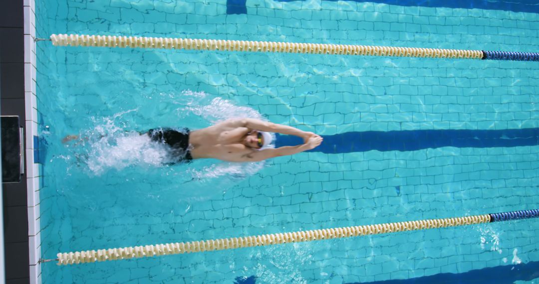 Competitive Swimmer Doing Backstroke in Swimming Pool from Above - Free Images, Stock Photos and Pictures on Pikwizard.com