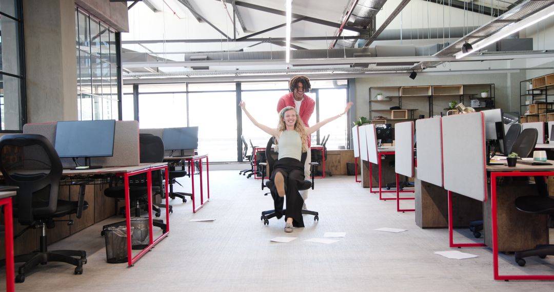 Colleagues Enjoying Playful Moment in Modern Office