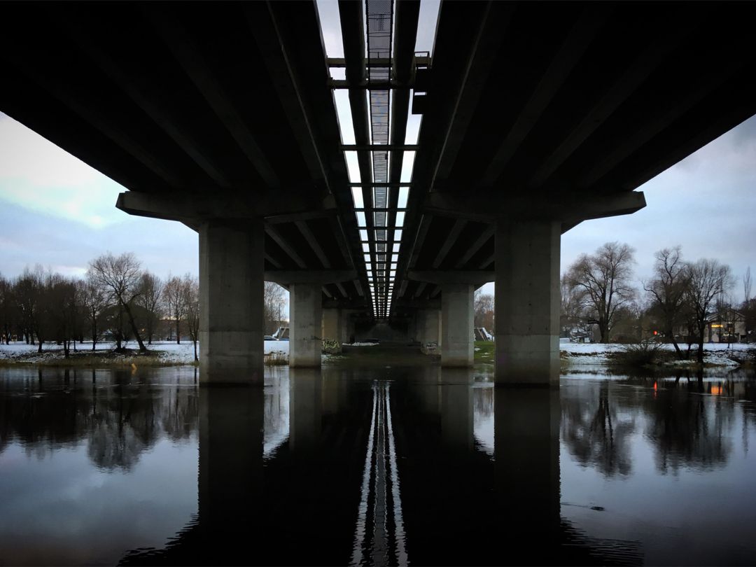 Symmetrical View Underneath Urban Bridge at Dusk