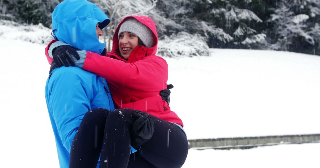 Couple Enjoying Winter Snow Day Outdoors - Free Images, Stock Photos and Pictures on Pikwizard.com