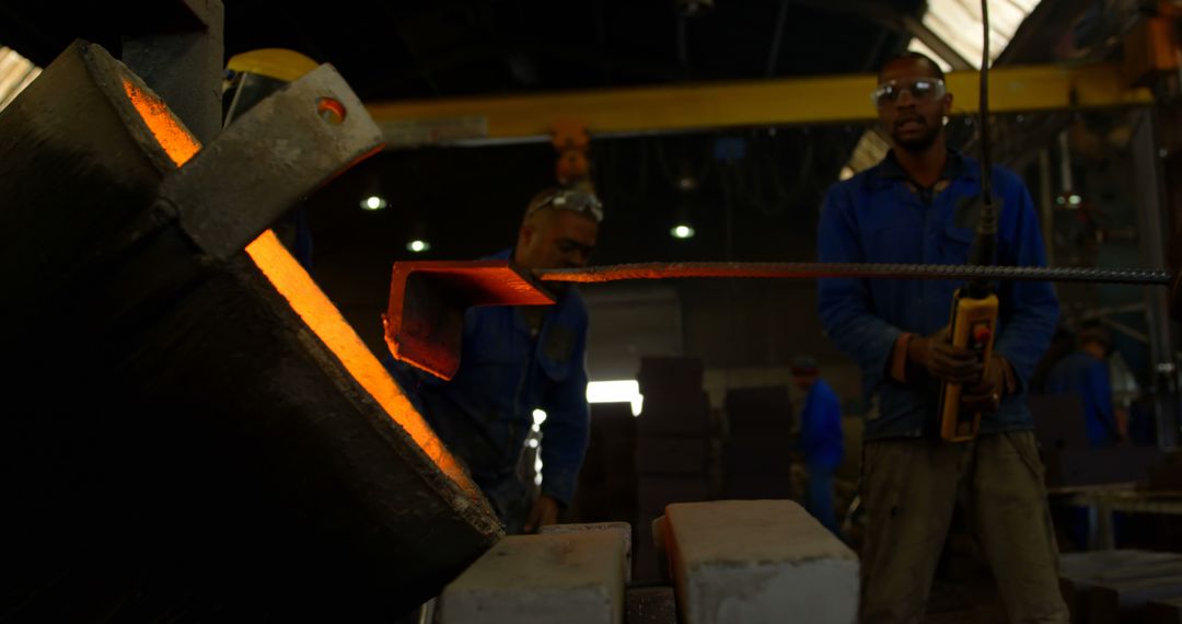 Workers Engaged in Process of Steel Forging in Industrial Workshop - Free Images, Stock Photos and Pictures on Pikwizard.com