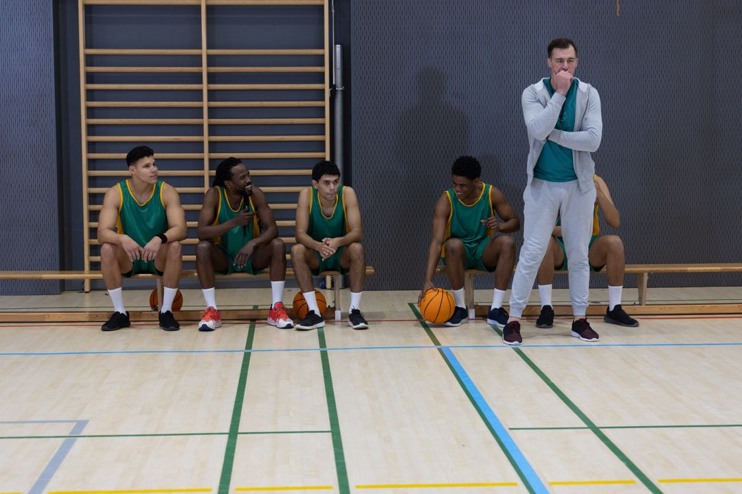 Basketball Team Engaged in Game Strategy Discussion on Bench
