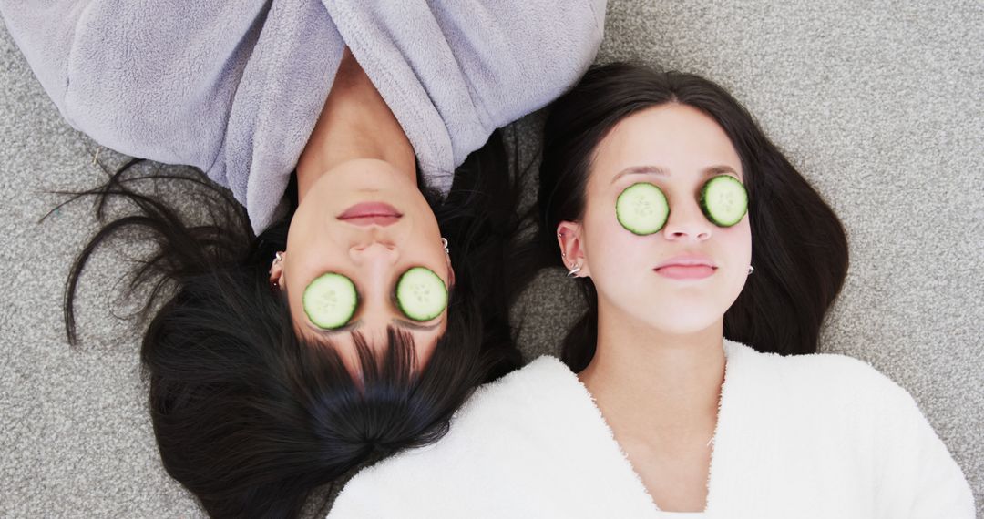 Two Women Relaxing with Cucumber Slices on Eyes During Spa Day - Free Images, Stock Photos and Pictures on Pikwizard.com