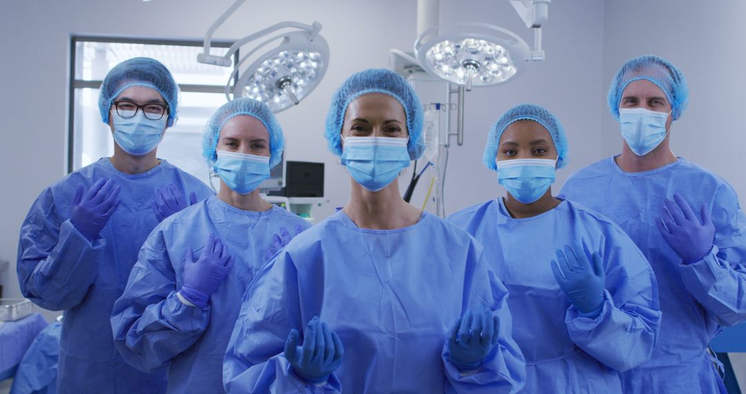 Healthcare Team Wearing Surgical Gowns in Operating Room - Free Images, Stock Photos and Pictures on Pikwizard.com