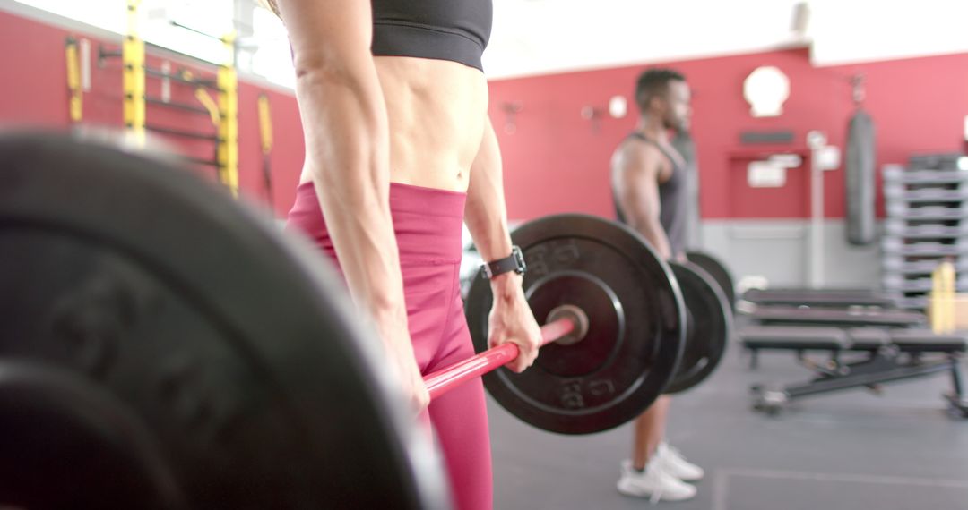 Focused Weightlifting Session with Diverse Duo at Gym