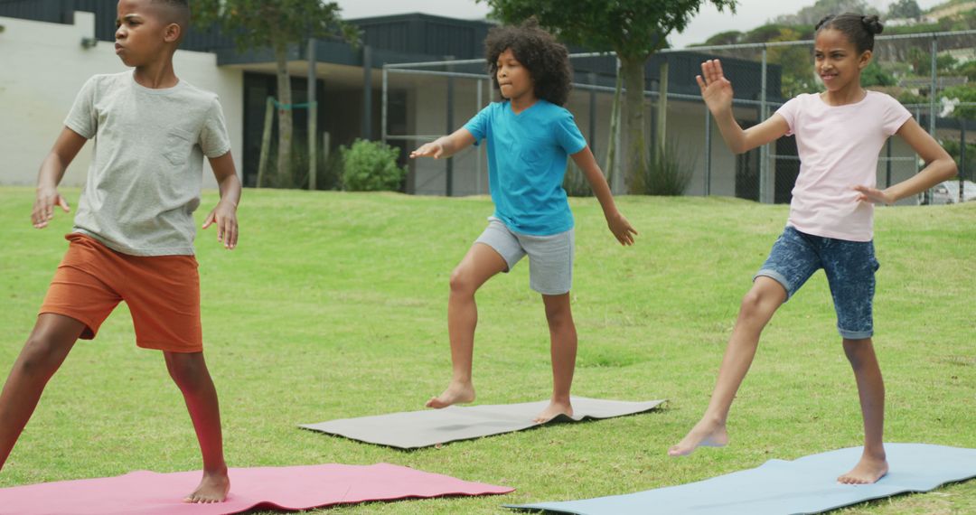 Image of three diverse schoolchildren practicing yoga in outdoor class, copy space - Free Images, Stock Photos and Pictures on Pikwizard.com