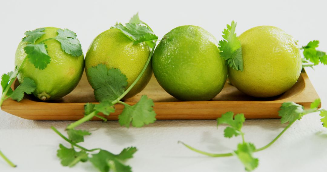 Limes with Fresh Cilantro on Wooden Tray - Free Images, Stock Photos and Pictures on Pikwizard.com