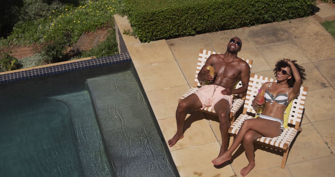 Couple Relaxing by Poolside with Refreshing Drinks on Sunny Day - Free Images, Stock Photos and Pictures on Pikwizard.com