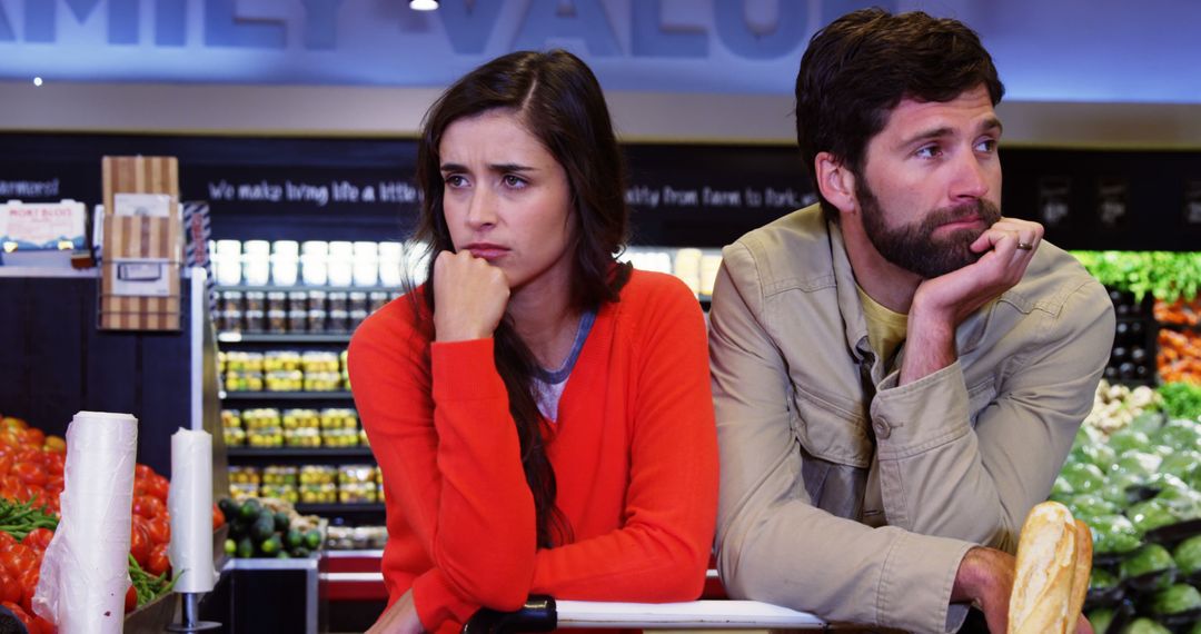 Couple Expressing Displeasure in Supermarket Produce Aisle