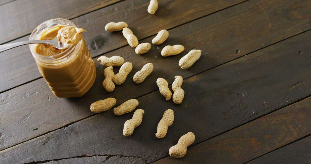 Peanut Butter and Peanuts Spread on Rustic Wooden Table