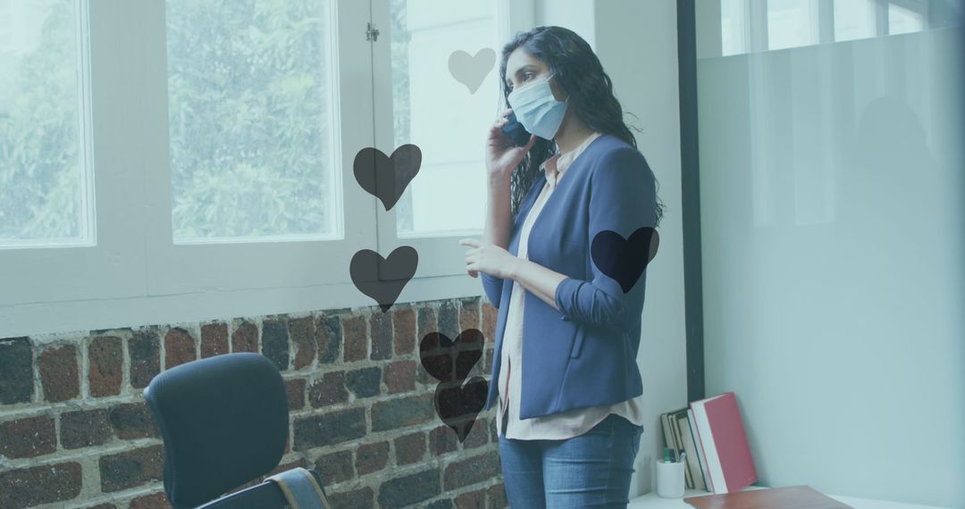 Businesswoman in Mask on Phone Call with Floating Hearts in Office