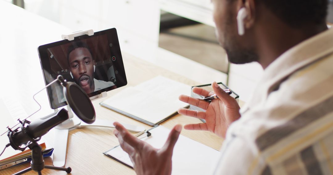 Man Conducting Online Meeting with Tablet and Microphone - Free Images, Stock Photos and Pictures on Pikwizard.com