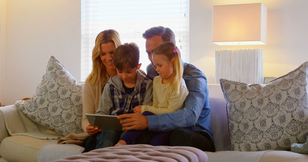 Happy Family Reading Tablet Together on Couch - Free Images, Stock Photos and Pictures on Pikwizard.com