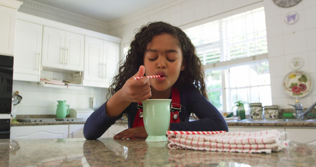 Young Girl Enjoying Hot Beverage in Cozy Kitchen - Free Images, Stock Photos and Pictures on Pikwizard.com