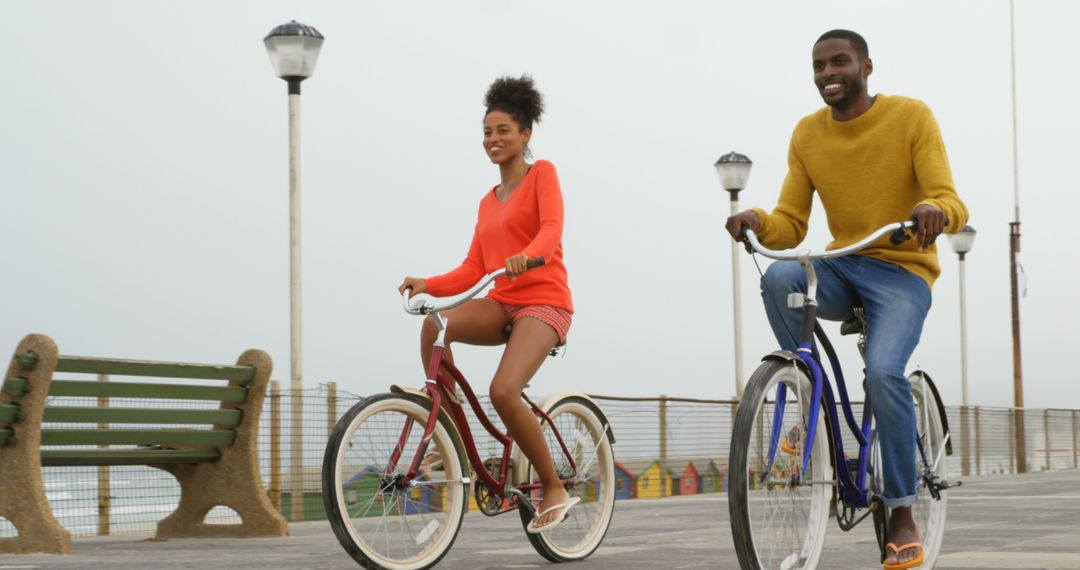 Smiling Couple Enjoying Relaxed Boardwalk Bicycle Ride