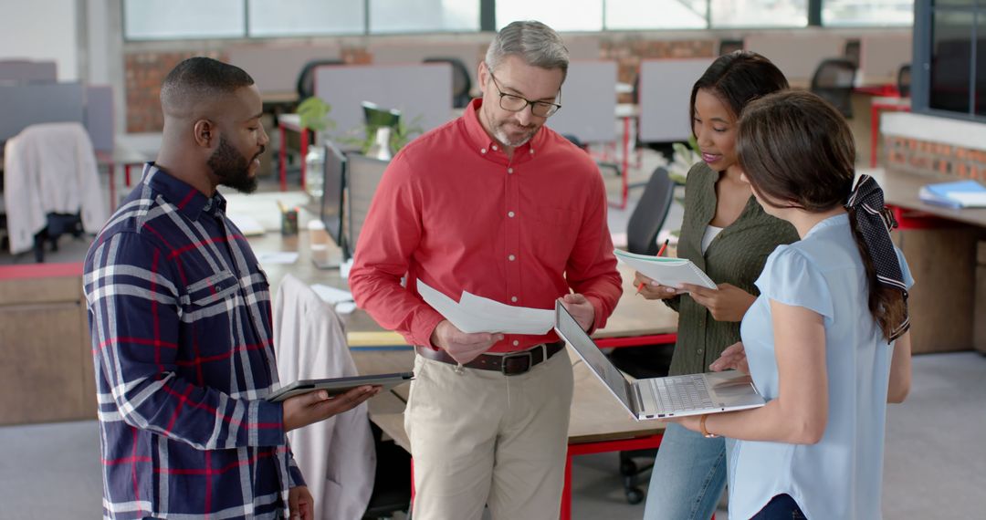 Diverse Team Collaborating on Project in Modern Office Space