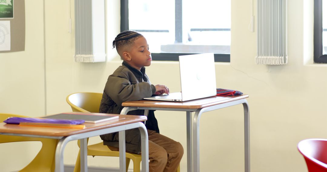 Young Student Engaged With Laptop in Classroom Environment