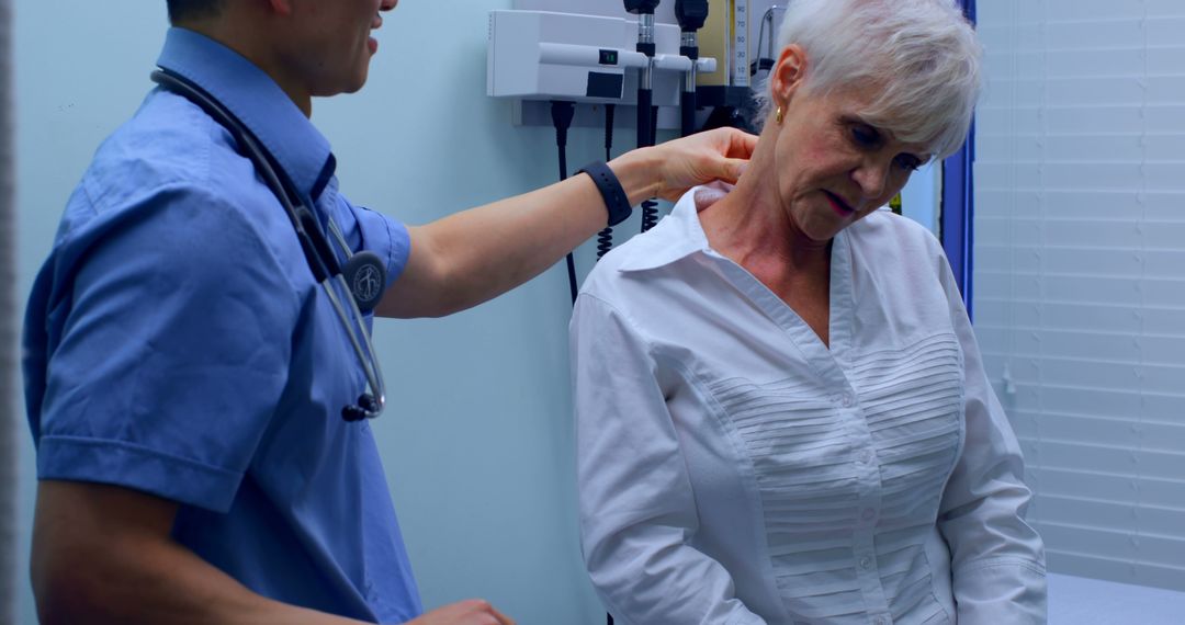 Doctor Examining Elderly Woman with Neck Pain in Clinical Setting - Free Images, Stock Photos and Pictures on Pikwizard.com