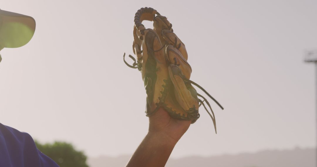 Baseball Player Holding Glove Up Against Clear Sky During Game - Free Images, Stock Photos and Pictures on Pikwizard.com