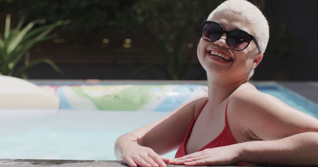 Smiling Woman in Sunglasses Relaxing at Poolside - Free Images, Stock Photos and Pictures on Pikwizard.com