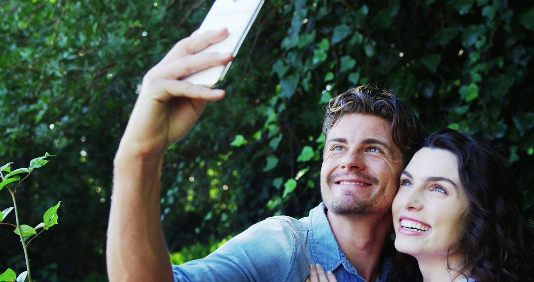 Happy Couple Taking Selfie in Lush Green Environment