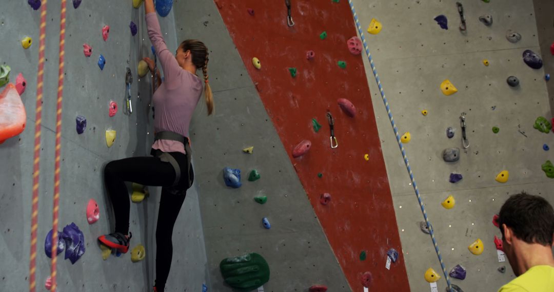 Young Woman Climbing Indoor Rock Wall in Gym - Free Images, Stock Photos and Pictures on Pikwizard.com