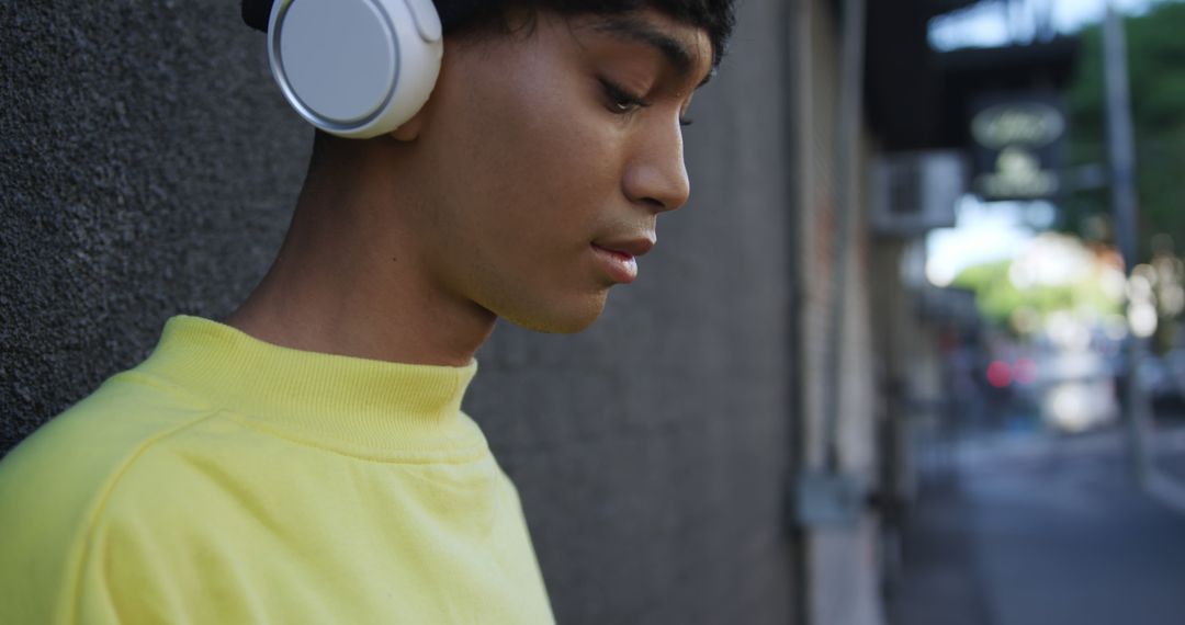 Young Man Wearing Headphones Relaxing Outdoors - Free Images, Stock Photos and Pictures on Pikwizard.com