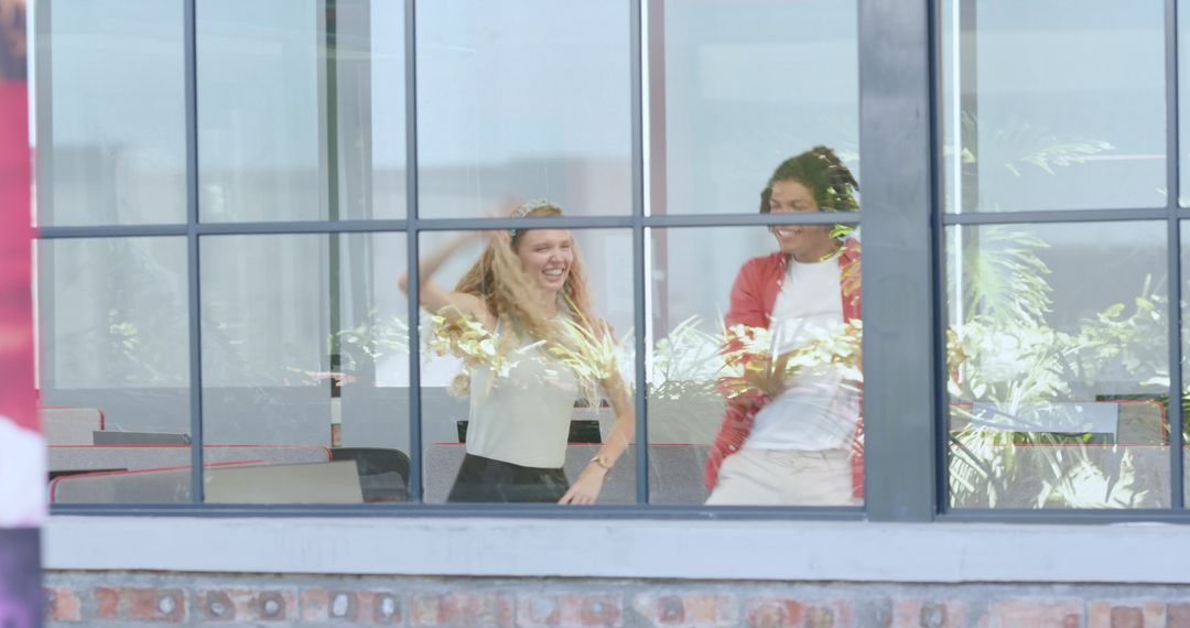 Colleagues Collaborating in Modern Office Seen Through Glass Window