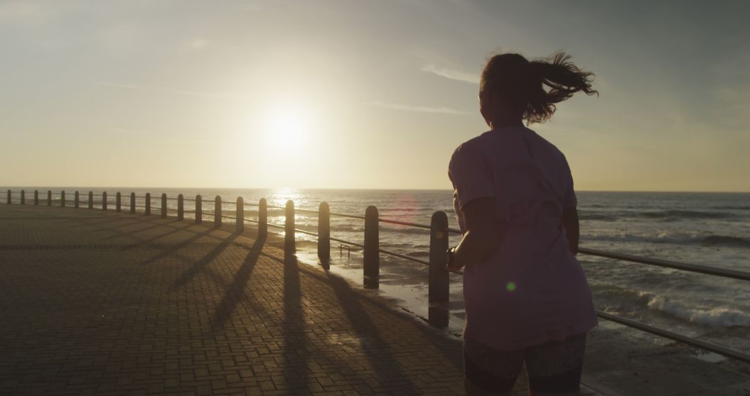 Woman Jogging at Sunrise by Ocean - Free Images, Stock Photos and Pictures on Pikwizard.com